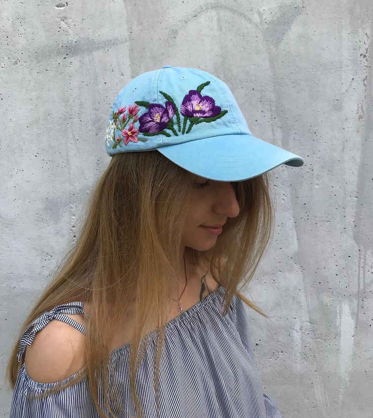 Embroider baseball hat with floral design Color: blue baseball cap. Design: hand embroidered crocuses with wildflowers. Cap size (head circumference): 55 - 67 cm. The quality of the embroidery and baseball cap is superior, I guarantee! ;) I really enjoyed making this, and I hope my customer will enjoy showing it off. 🌿 PLEASE NOTE I NEED 10 DAYS TO EMBROIDER THIS HAT FOR YOU🌿 GET 10% OFF YOUR 1ST ORDER! Get a 10% off coupon code for our Etsy shop by signing up to our mailing list eepurl.com/ge Spring Blue Baseball Cap With Embroidered Logo, Blue Hats With Embroidered Logo For Spring, Blue Spring Hats With Embroidered Logo, Spring Blue Hats With Embroidered Logo, Handmade Hats As Spring Gifts, Curved Brim Hats For Spring Gifts, Curved Brim Hats For Spring Gift, Curved Brim Hat For Spring, Handmade Snapback Hats For Spring