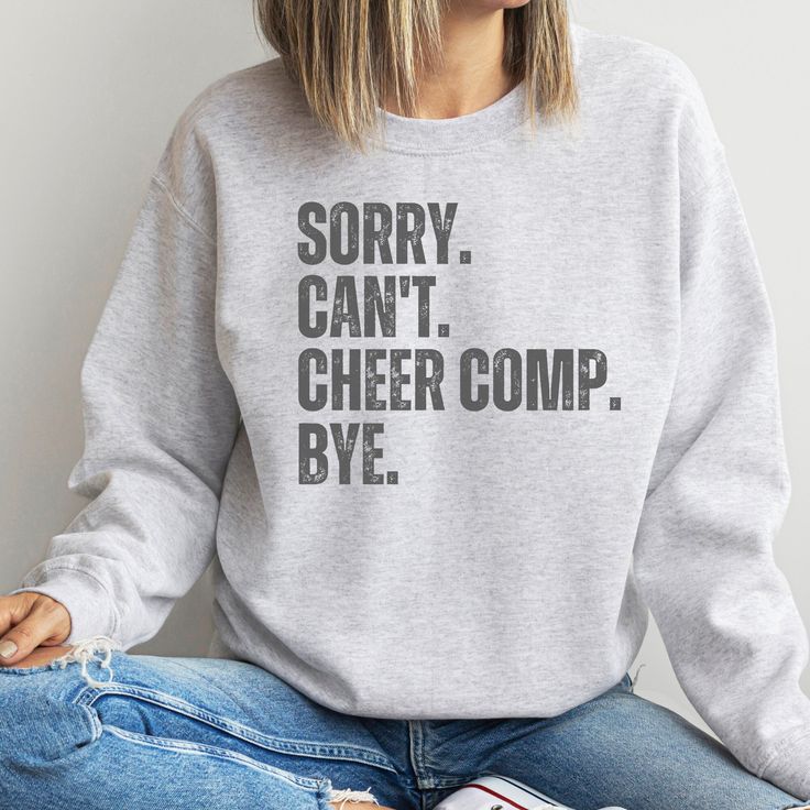 "Designed with cheerleaders and their supporters in mind, this sweatshirt is more than just apparel; it's a statement of dedication to the world of cheerleading. Whether you're gearing up for a college cheer competition or cheering from the sidelines, this sweatshirt will keep you cozy and motivated. With its stylish design and catchy slogan, you'll stand out as a cheer enthusiast. It's the perfect gift for fellow cheerleaders, cheer moms, or coaches who pour their hearts into this exhilarating sport. Say goodbye to chilly competition days and hello to comfort, style, and confidence! These garments are made from polyester and cotton. This combination helps designs come out looking fresh and beautiful. The collar is ribbed knit, so it retains its shape even after washing. There are no itchy College Team Spirit Sweatshirt In Athletic Heather, Athletic Heather College Sweatshirt For Team Spirit, Pre-shrunk Long Sleeve Sweatshirt For Cheerleading, Pre-shrunk Long Sleeve Cheerleading Sweatshirt, Team-colored Sweatshirt For Cheerleading With Team Name, Collegiate Sweatshirt With Team Name For Cheerleading, Fall Cheerleading Crew Neck Sweatshirt, Sporty Cotton Sweatshirt For Cheerleading, Fall Crew Neck Sweatshirt For Cheerleading