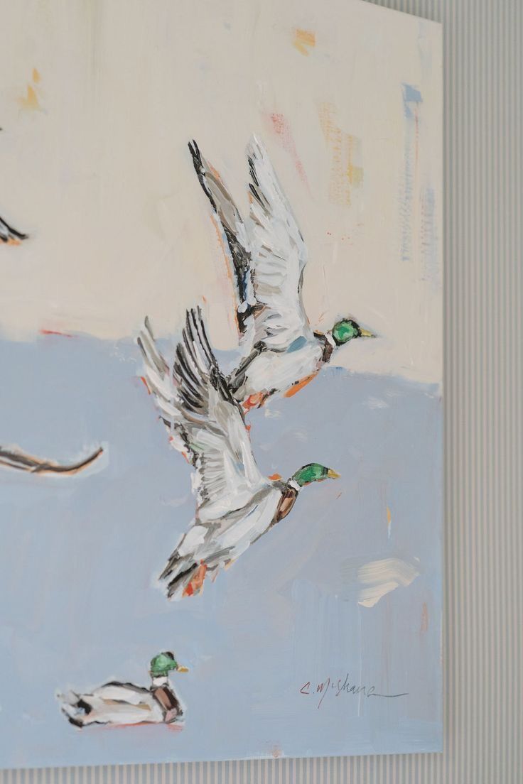 two ducks are flying in the air near each other