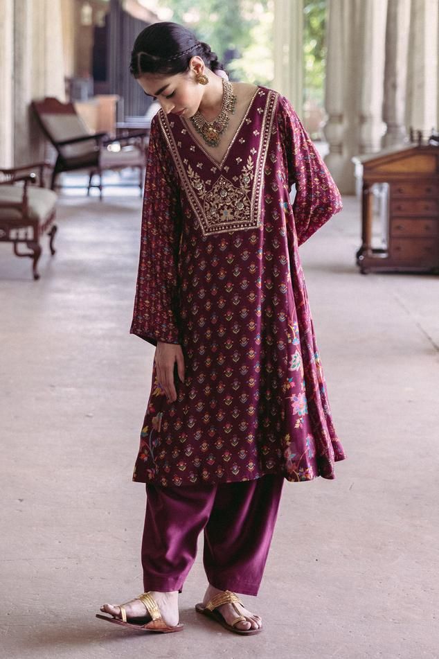 Plum kalidar kurta with floral print and aari, anchor threads, sequins, mirror hand embroidered yoke. Paired with a chanderi silk solid salwar.   
Components: 2
Pattern: Printed, Embroidered, Woven
Type Of Work: Floral
Neckline: V neck
Sleeve Type: Full
Fabric: Kurta: Dupion Silk, Pants: Chanderi, Lining: Crepe
Color: Purple
Other Details: 
Hand embroidered
Length:
Front Neck: 9.5 inches Kalidar Kurta Pattern, Blouse Yoke, Indian Designers, Kurta Patterns, Designer Store, Dupion Silk, Silk Pants, Mixing Prints, Indian Design