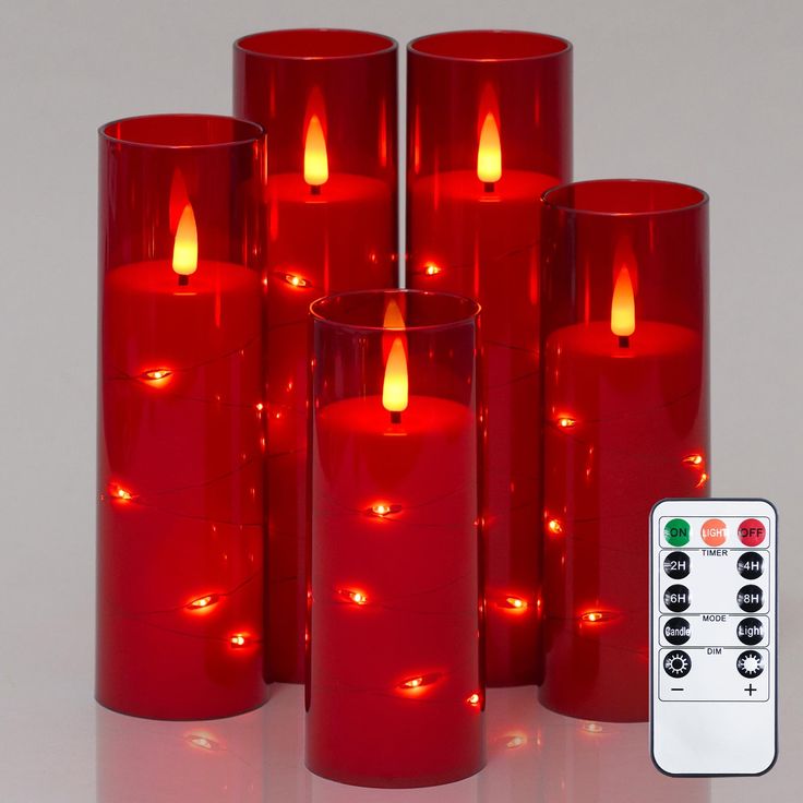 several red candles with remote controls in front of them