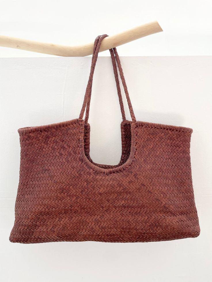 Introducing our handwoven leather tote Narmada bag, meticulously crafted from leather weaving straps in India. This spacious yet elegant accessory is the epitome of convenience and sustainability. Perfect for your everyday life from work to grocery shopping, it effortlessly carries all your essentials with ease. With its eco-friendly material and artisanal craftsmanship, it's not just a bag—it's a statement of conscious living. Embrace practical luxury with our gorgeous tote, where functionality Rectangular Woven Leather Hobo Bag For Shopping, Rectangular Natural Bucket Bag With Intrecciato Weave, Intrecciato Weave Hobo Tote Bag For Daily Use, Woven Leather Bucket Bag For Market, Everyday Bags With Interwoven Design And Top Handle, Everyday Bags With Top Handle And Interwoven Design, Handwoven Leather Hobo Bag, Handwoven Leather Bucket Bag For Daily Use, Woven Leather Tote Hobo Bag