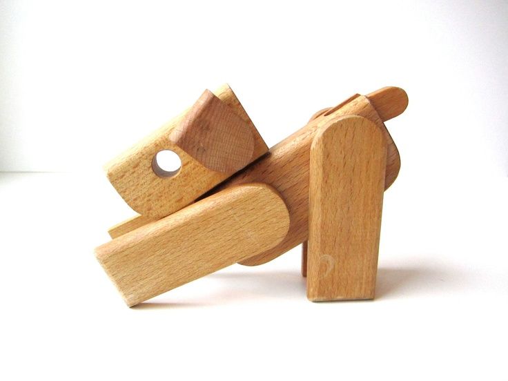 a wooden toy dog on a white background