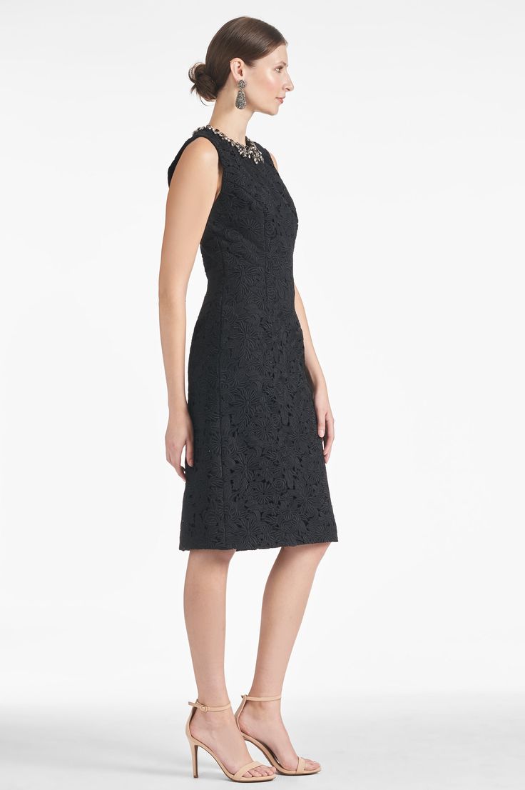 The Anna Dress - Noir is the perfect combination of timeless elegance and feminine grace. With its embellished neckline and lace body, the dress is the perfect length, color, and silhouette for any special occasion. Details:Model is 5'10" wearing size 242" Long Back Zipper Thick Lace100% Polyester ImportedStyle #F231D08-001 Evening Knee-length Midi Dress With Scalloped Lace, Sheath Lace Dress With Lace Trim For Evening, Formal Scalloped Lace Midi Dress, Formal Midi Dress With Scalloped Lace, Elegant Lace Midi-length Mother Of The Bride Dress, Elegant Lace Midi Dress For Party, Dressy Midi-length Lace Dress For Formal Occasions, Formal Dressy Lace Dress, Luxury Sleeveless Lace Evening Dress