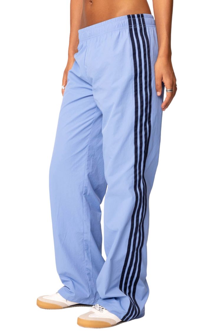 Sporty stripes make their mark on these lightweight pants that have a comfy elastic waistband for easy stretch. Elastic waist 100% nylon Machine wash, line dry Imported Athleisure Pants With Three Stripes In Relaxed Fit, Athleisure Relaxed Fit Pants With Three Stripes, Striped Sporty Bottoms For Sports, Sporty Striped Bottoms For Sports, Sporty Striped Sports Bottoms, Spring Athleisure Pants With Three Stripes, Athleisure Straight Leg Bottoms With Side Stripes, Blue Athleisure Sweatpants With Elastic Side Panels, Stretch Athleisure Pants With Three Stripes