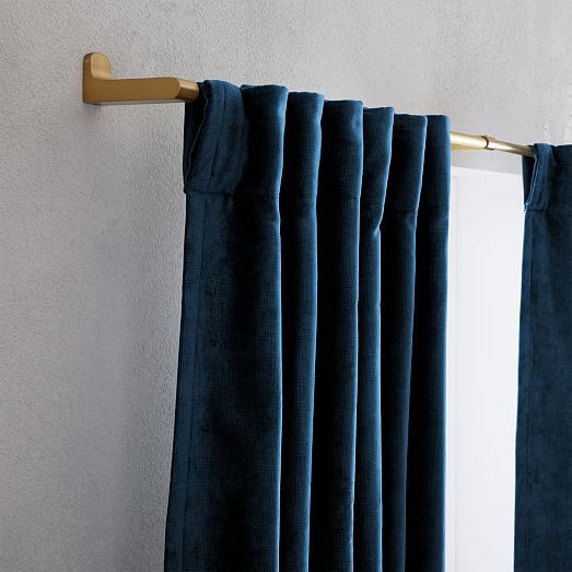 the curtain is hanging on the wall next to the window with curtains pulled back and closed