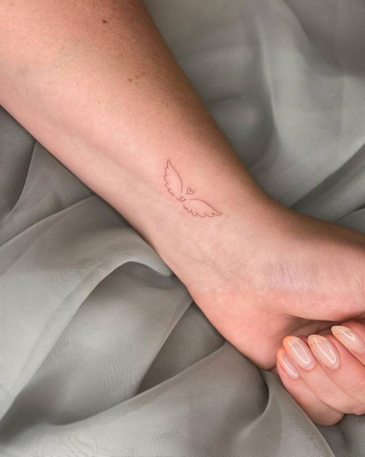 a woman's foot with a small tattoo on it