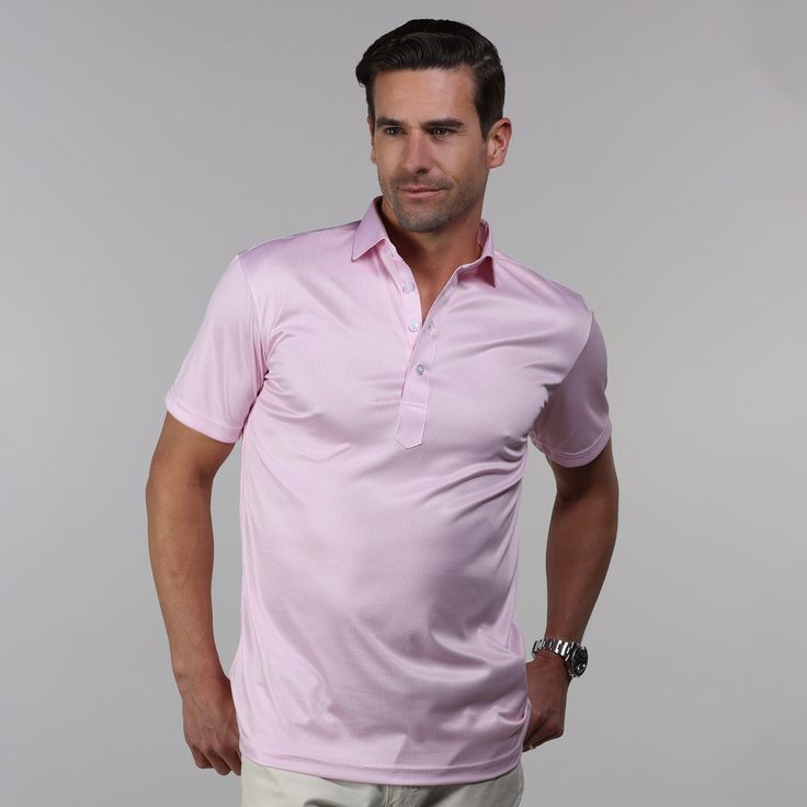 The versatile Semi-Spread Collar Polo. Woven for comfort and designed for style. This shirt pairs a formal semi spread dress collar with an extra comfortable, 4-way stretch, short-sleeved polo. The semi-spread collar has all the benefits of our ever popular English spread collar with a streamlined size and built to accommodate a larger tie knot Throw a sweater on over it or a tie and jacket to be comfortable for work, a date or zoom call. Get all the upside of a formal collar without the discomf Classic Short Sleeve Golf Shirt, Short Sleeve Polo Shirt For Summer Golf, Spring Short Sleeve Golf Polo Shirt, Spring Golf Polo Shirt With Short Sleeves, Summer Short Sleeve Polo Shirt For Golf, Formal Fitted Polo Shirt With Placket, Fitted Short Sleeve Golf Shirt, Formal Summer Collared Polo Shirt, Formal Summer Polo Shirt