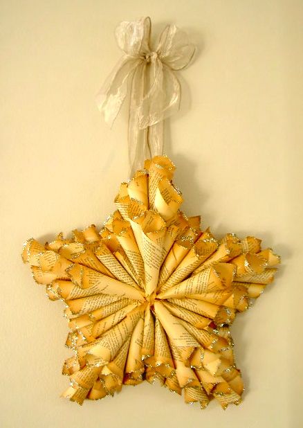 an ornament hanging on the wall is made out of gold ribbon and bows