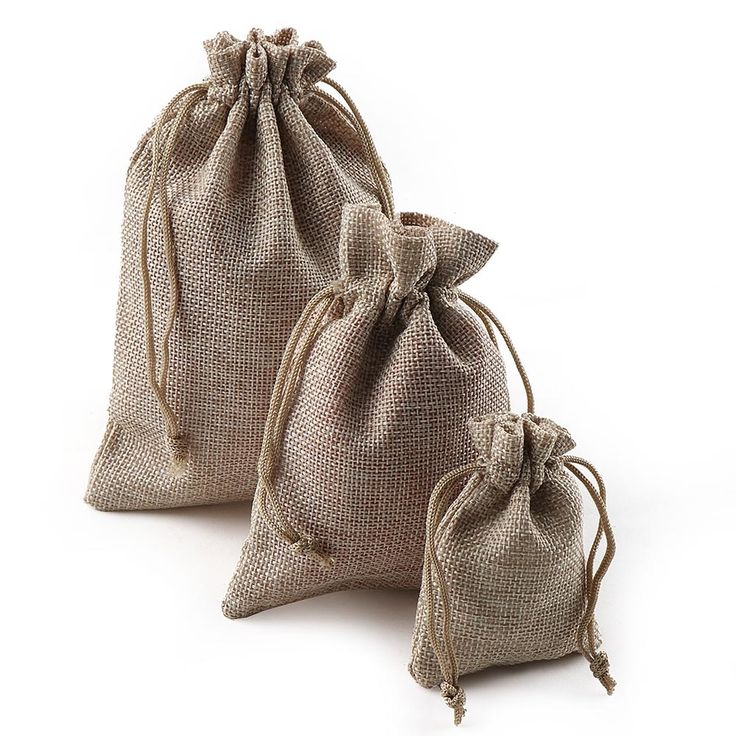 two burlap bags sitting next to each other on a white surface with no one in them