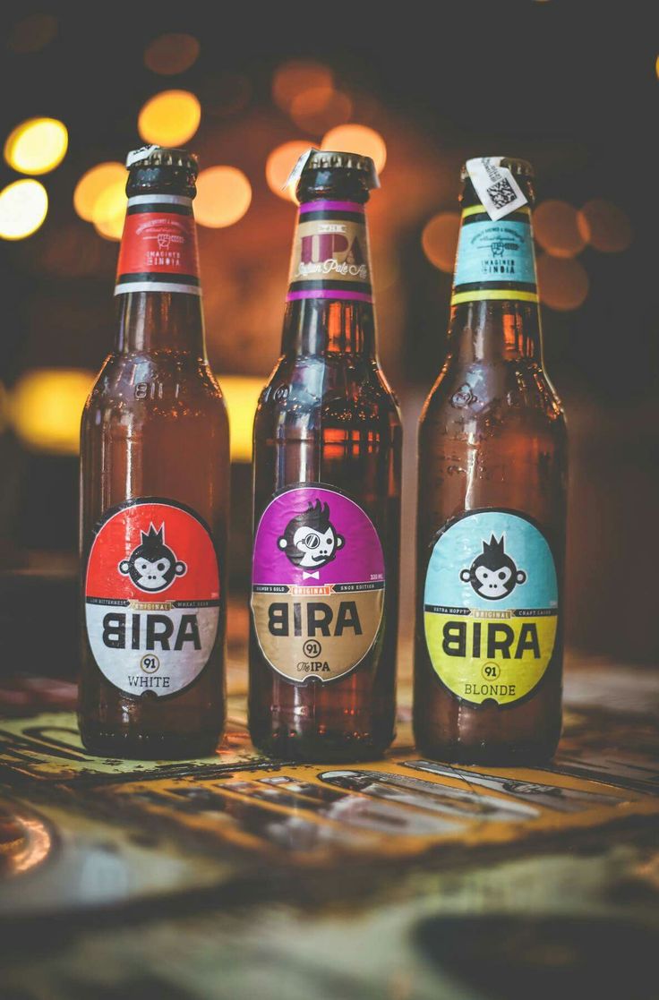 three beer bottles sitting on top of a table