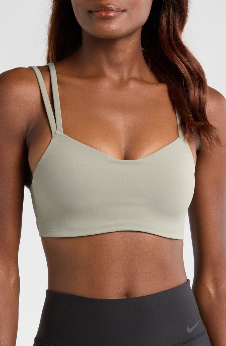 Signature Dri-FIT tech keeps you dry and comfortable in this strappy sports bra with a foam pad insert for extra coverage. Elasticized straps Dri-FIT moisture-wicking technology Lined 63% nylon, 37% spandex Machine wash, line dry Imported Strappy Sports Bra With Built-in Bra, Nike Sports Bra With Built-in Bra For Training, Nike Sports Bra With Built-in Bra For Yoga, Nike Yoga Sports Bra With Built-in Bra, Light Support Sports Bra With Tank Straps For Training, Nike Seamless Sports Bra For Training, Adjustable 4-way Stretch Sports Bra For Light Exercise, Adjustable Straps Sports Bra For Light Exercise, Solid Sports Bra With Light Support And Strappy Back