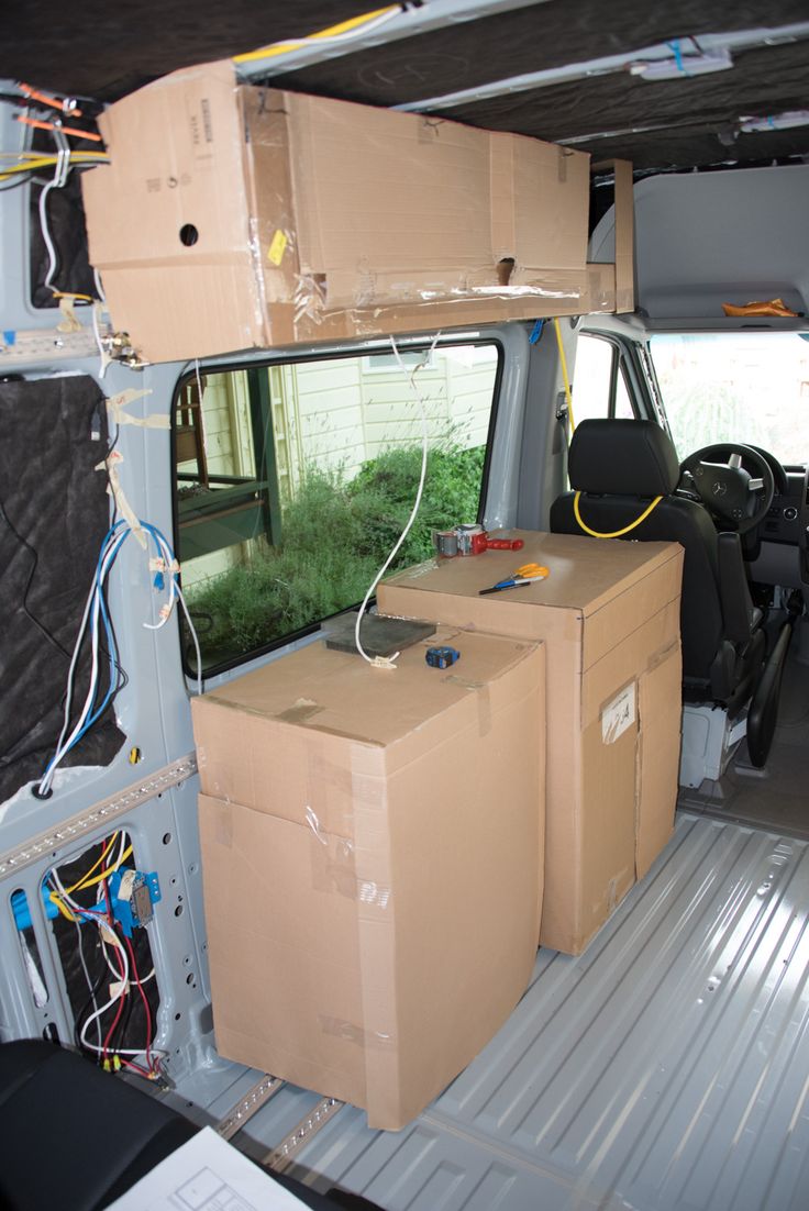 the inside of a van with boxes and wires