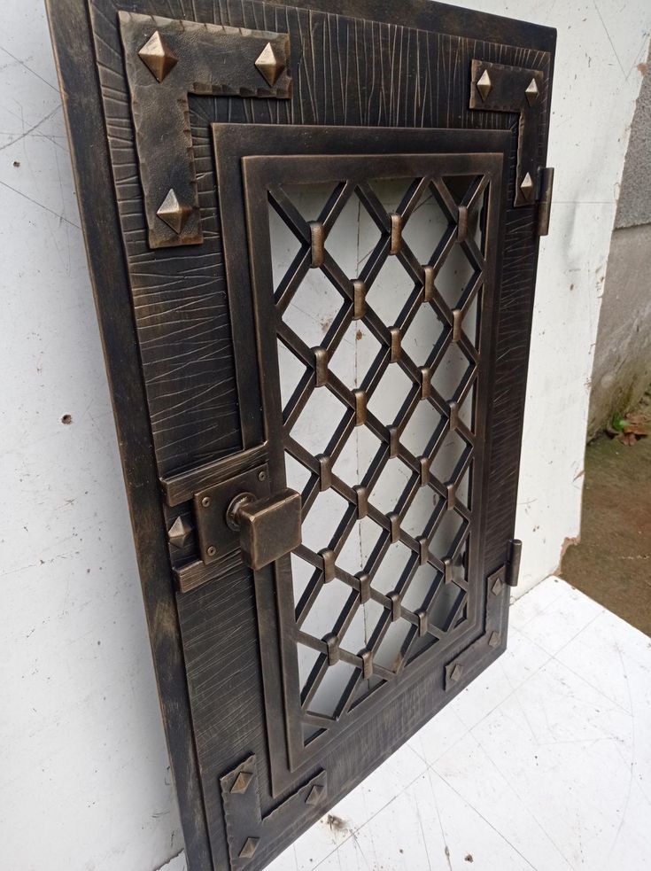 the door is made out of wood and has rivets on it's sides