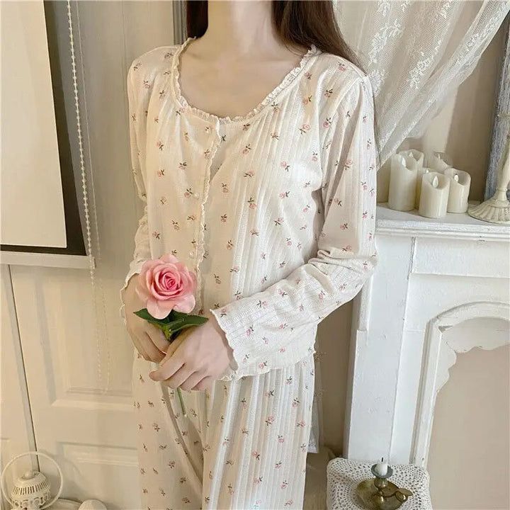 The Coquette Floral Pajama Set is a luxurious sleepwear ensemble that will help you get a restorative night's sleep. Crafted from luxuriously soft cotton, these PJs feature beautiful floral detailing that will have you looking and feeling your best. Relax in total comfort with this set that is designed to keep you cozy and stylish all night long. Feminine Floral Print Long Sleeve Sleepwear, Casual Floral Print Nightgown For Pajama Party, Casual Nightgown For Pajama Party In Spring, Casual Long Sleeve Floral Print Nightgown, Casual Long Sleeve Nightgown With Floral Print, Cotton Floral Print Nightgown For Loungewear, Floral Print Long Sleeve Nightgown For Loungewear, Feminine Cotton Sleepwear Set, Feminine Cotton Sleepwear For Sleepover