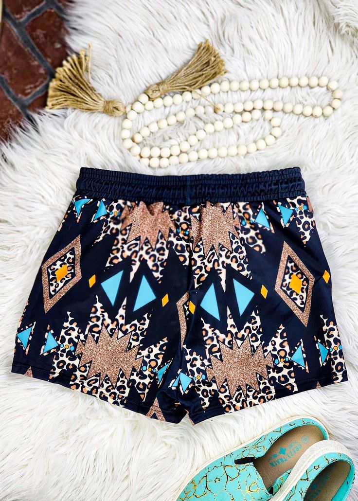 These Leopard Aztec Drawstring Shorts make a bold statement with their unique bling and cowgirl-inspired style. Stay cool and stylish this summer in these one-of-a-kind shorts! Who says fashion can't be fun? 95% polyester and 5% spandex Regular fit True to size - size chart available in photos Care Instruction: machine wash cold with similar colors, do not bleach, tumble dry low, do not iron, do not dry clean. This item ships in 14 +/- days. Stretch Beachwear Shorts For Festival, Casual Adjustable Shorts For Summer, Adjustable Casual Shorts For Summer, Summer Festival Stretch Bottoms, Multicolor Short Swimwear For Festival, Casual Adjustable Short Bottoms, Bohemian Bottoms For Summer Music Festival, Bohemian Stretch Shorts For Festivals, Casual Adjustable Shorts