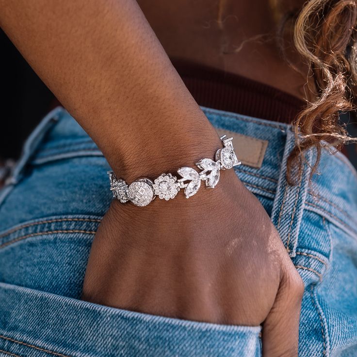 Ice out your wrist with the Diamond Flower Bracelet in 14k White Gold. This piece is meticulously crafted, featuring an intricate pattern of bold hand-set stones and finished with a unique hidden clasp. To open the bracelet, find the circle with GLD stars, and slide the magnetic closure up or down for easy on and off. Step up your style game with this exclusive piece, it's perfect to pair with any fit anywhere you go. This product is guaranteed for life – GLD will repair or replace the item shou Formal Jewelry With Diamond Accents And Flower Shape, Formal Flower Shaped Jewelry With Diamond Accents, Formal Flower-shaped Jewelry With Diamond Accents, Fine Jewelry Cubic Zirconia Flower Jewelry, Fine Jewelry Flower Shaped Cubic Zirconia Jewelry, Fine Jewelry Flower-shaped Cubic Zirconia Jewelry, Elegant Diamond Flower Bracelet, Exquisite Flower Shaped Jewelry With Diamond Accents, Exquisite Flower-shaped Jewelry With Diamond Accents