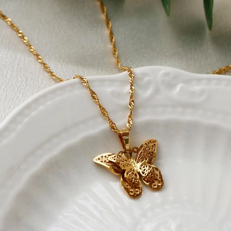 Beauty of nature and the elegance of gold with our 18K Gold Butterfly Pendant Necklace. Elevate your style, celebrate life's moments, and embrace the grace of the butterfly with this captivating and unforgettable piece. Its clean lines and graceful form make it a versatile piece that effortlessly complements a range of styles, from understated elegance to modern chic.- 40cm + 5cm =45cm total length- 18k gold filled - glossy gold finish★- on vintage gold side★- lobster claw closure- tarnish resis Elegant Butterfly Pendant Necklace With Butterfly Clasp, Elegant Rose Gold Necklace With Butterfly Charm, Elegant Butterfly Necklace For Formal Occasions, Elegant Butterfly Jewelry As A Gift For Her, Elegant Butterfly Jewelry Gift For Her, Elegant Butterfly Shaped Filigree Jewelry, Elegant Butterfly Filigree Jewelry, Elegant Yellow Gold Butterfly Jewelry, Elegant Yellow Gold Butterfly Necklace