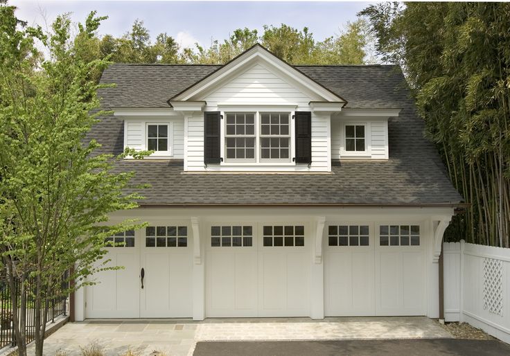 a white house with black shutters and windows