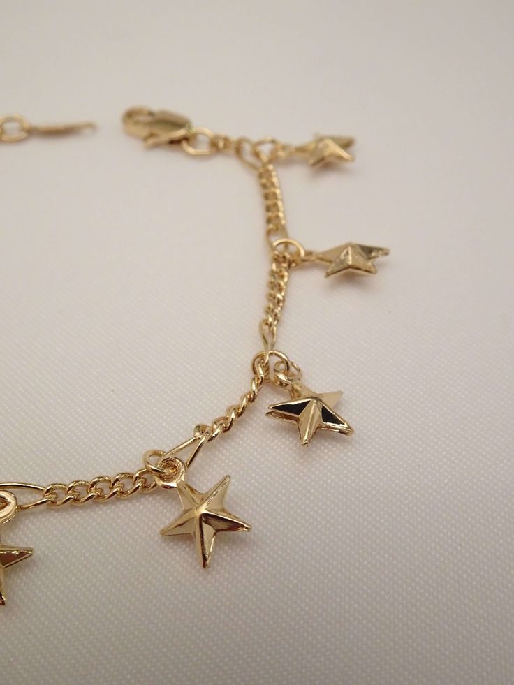 The stars lined up when this beauty was created! The Star Bracelet is one superstar! This star charm bracelet features an infinity dainty bracelet adorned with tiny puff star charms. Best of all, she comes in anklet form too! Your sure to stir a sensation with this cutie! Knock this look out of this galaxy with these must have star jewelry pieces too! - The Star Choker Necklace - The Starburst Earrings - The Moon and Star Necklace Available in 24K gold or rhodium plating over steel Size: 7" (we Star Charm Bracelet, Moon And Star Necklace, Starburst Earrings, Dainty Bracelet, Star Bracelet, Star Jewelry, Dainty Bracelets, Star Charms, Star Necklace