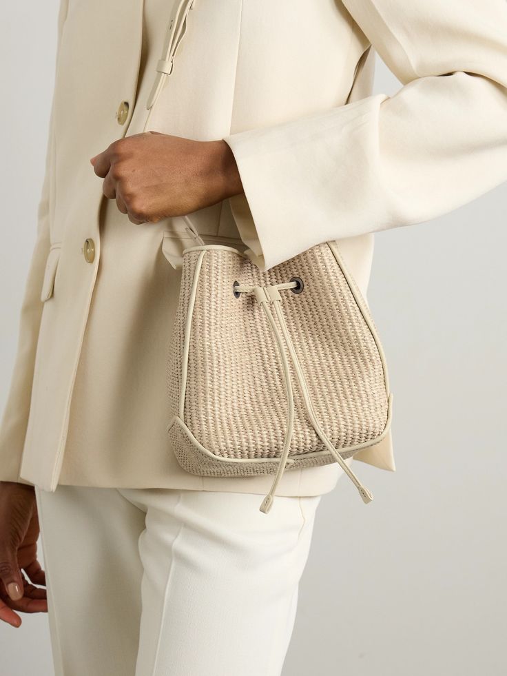 Brunello Cucinelli's bag re-imagines classic bucket styles for summer. It's been crafted in Italy from raffia and has adjustable leather straps tipped with the label's signature Monili beads. The compact size fits your phone, sunglasses and keys. Designer Summer Straw Bucket Bag, Designer Bucket Shoulder Bag For Spring, Designer Summer Bucket Bag For Vacation, Classic Summer Vacation Bags, Designer Summer Bucket Bag With Leather Handles, Elegant Woven Leather Bucket Bag For Travel, Designer Bucket Bag For Summer, Elegant Straw Shoulder Bag With Adjustable Strap, Elegant Leather Bucket Bag For Vacation