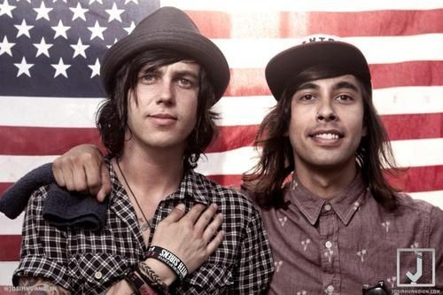 two men standing next to each other in front of an american flag with the caption, i pledge allegiance to try taco