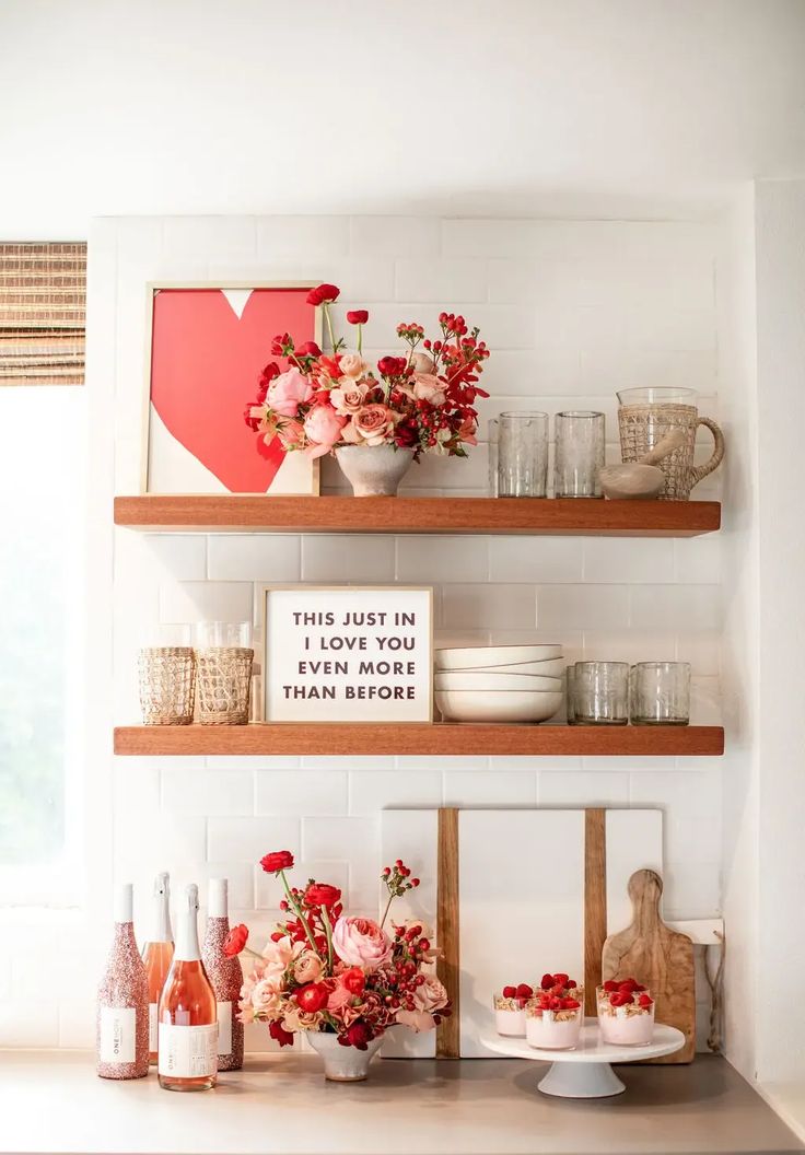 the shelves in this kitchen are decorated with flowers and vases on top of them