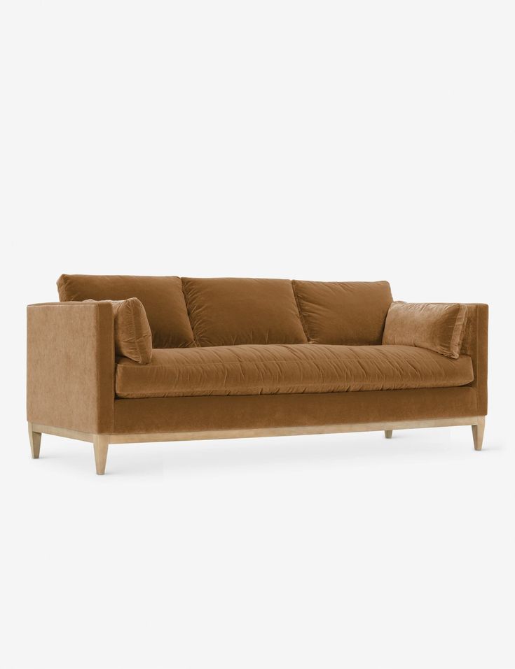 a brown couch sitting on top of a white floor