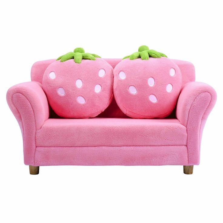 two stuffed strawberrys sitting on top of a pink couch with white polka dot dots