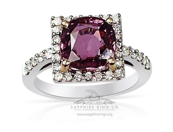 an engagement ring with a pink stone surrounded by diamonds