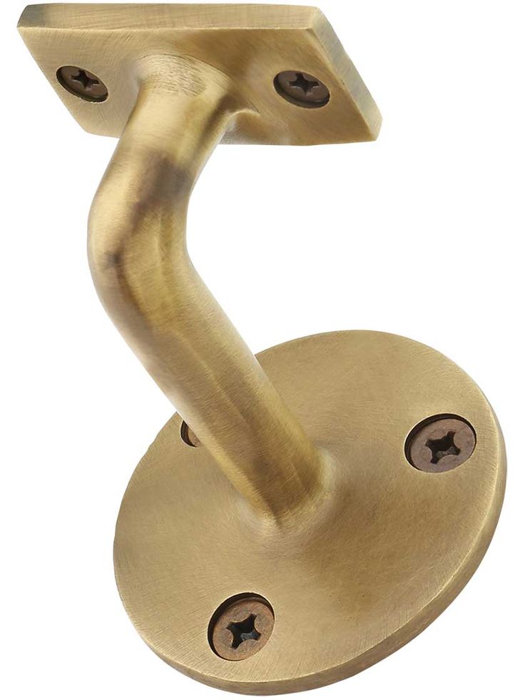 an antique brass door handle on a white background