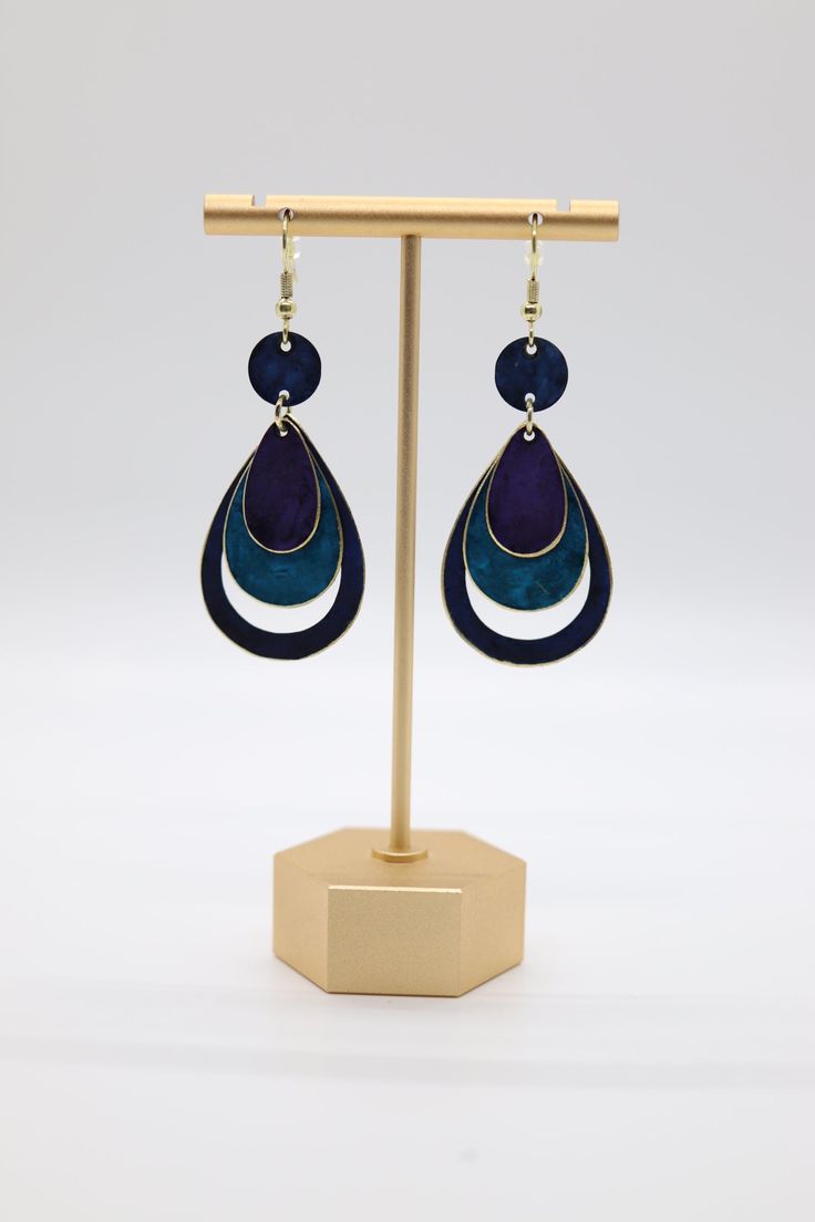 These layered black, purple, and blue teardrop earrings are a must-have for any fashionista. The unique combination of colors and the teardrop shape make these earrings perfect for any occasion. Wear them with a casual outfit for a day out on the town, or dress them up for a special evening. Either way, you'll love the way they look and the compliments you're sure to receive. Trendy Blue Dangle Teardrop Earrings, Trendy Blue Teardrop Earrings For Gifting, Trendy Blue Teardrop Earrings For Gift, Trendy Blue Teardrop Earrings Gift, Blue Teardrop Hypoallergenic Hoop Earrings, Blue Hypoallergenic Teardrop Hoop Earrings, Everyday Earrings, Christmas Sale, Teardrop Earrings