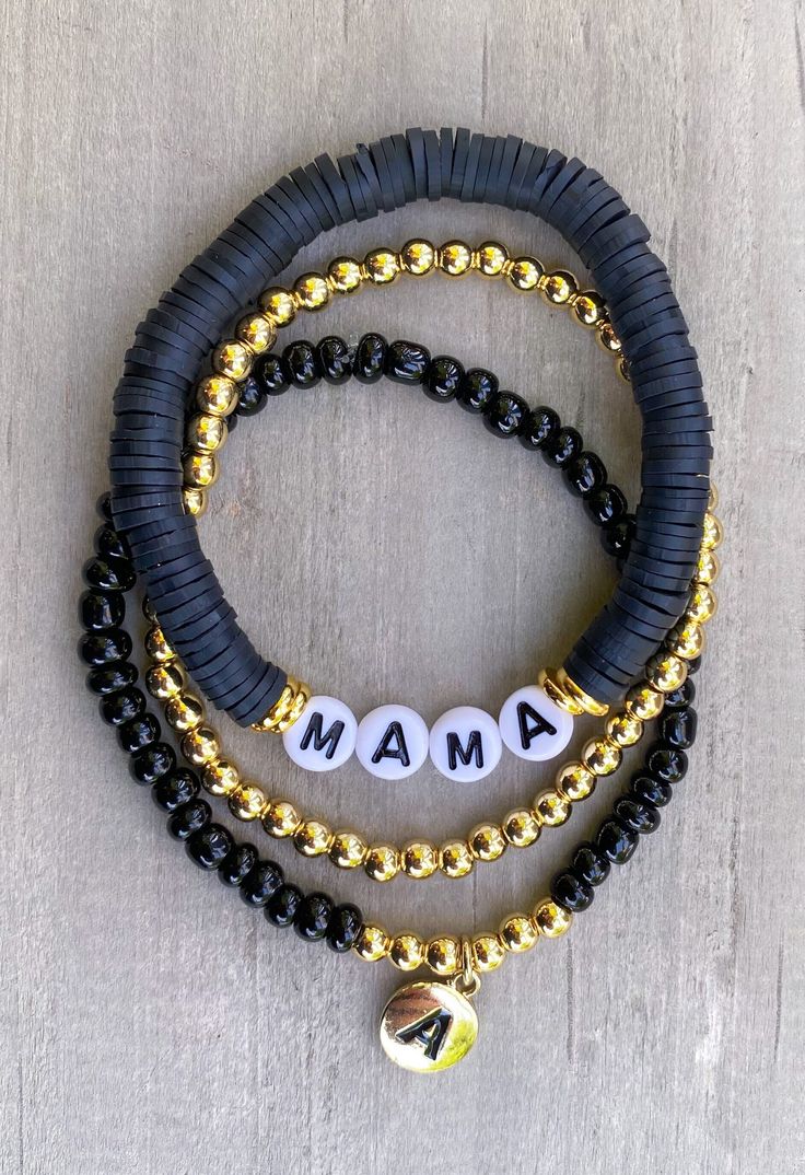 "Mama Bracelet 🖤🖤 Simple, chic Mama bracelet, looks cute with any attire!  Made with black clay beads beads, 18k gold accents and gold circle letters that read \"Mama\" Gold bracelet and accents on bracelets are 18k gold filled  If you would like another word or color, please put in Personalization Section* and we will contact you if we have questions.  CARING TIPS FOR YOUR JEWELRY ⭐️Treat and store with care. ⭐️ For longevity, avoid exposing your jewelry to water. ⭐️ Avoid having direct contact with lotions, perfumes, sanitizers as these chemicals may cause discoloration of your jewelry." Black And Gold Clay Bead Bracelet, Head Bracelet Ideas, Black Heishi Beads Bracelet With Colorful Beads, Black Heishi Beads Stretch Bracelet As Gift, Handmade Black Heishi Beads Stretch Bracelet, Black Heishi Beads Bracelet As Gift, Black Heishi Beads Beaded Bracelets, Black Bangle Jewelry With Colorful Beads, Black Heishi Beads Bracelet