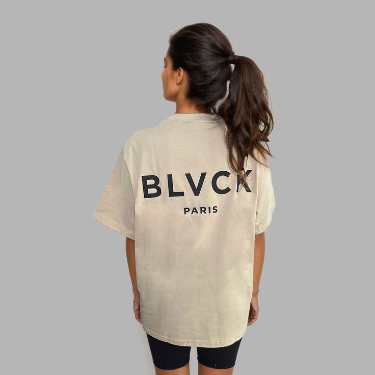 Introducing Shades of Blvck, our latest collection of essentials, available in three different shades. The Blvck Tee 'Twilight' boasts a beige tone and an oversized fit. The back features a bold 'Blvck Paris' logo in UV print and the front features a subtle logo in the chest in UV rubber print. Crafted from a luxurious blend of fleece cotton, it's impossibly soft to the touch and lends a perfect fit for whichever activity the day may bring. Trendy Beige Streetwear T-shirt, Trendy Beige T-shirt For Streetwear, Oversized Beige T-shirt For Streetwear, Urban Beige Tops For Streetwear, Blvck Paris, Rubber Print, Paris Logo, Uv Print, Womens Tees