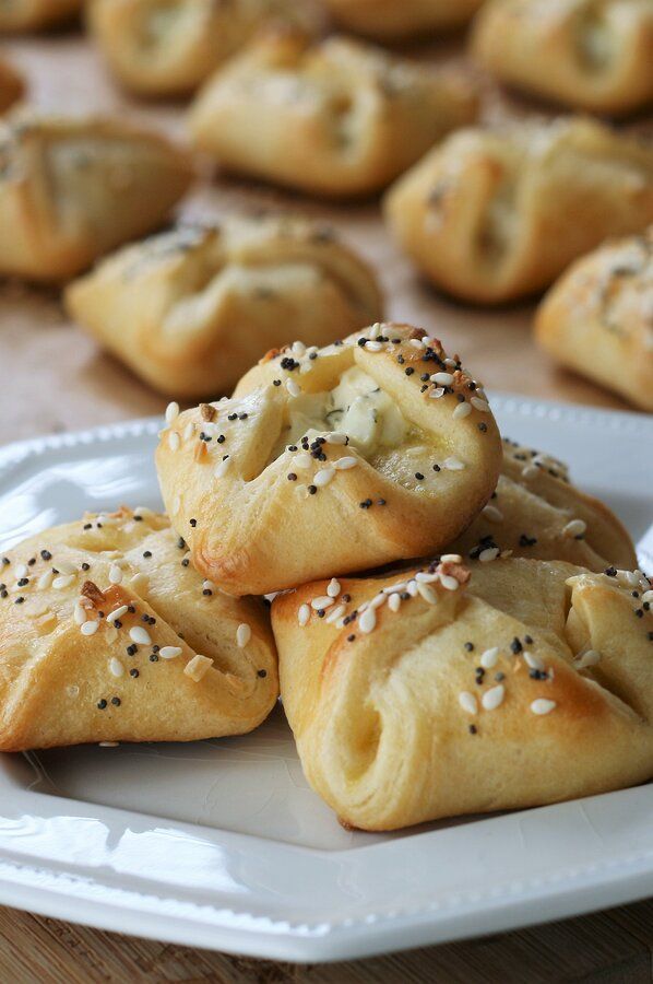 small pastries on a white plate with sprinkles and sesame seeds in the middle