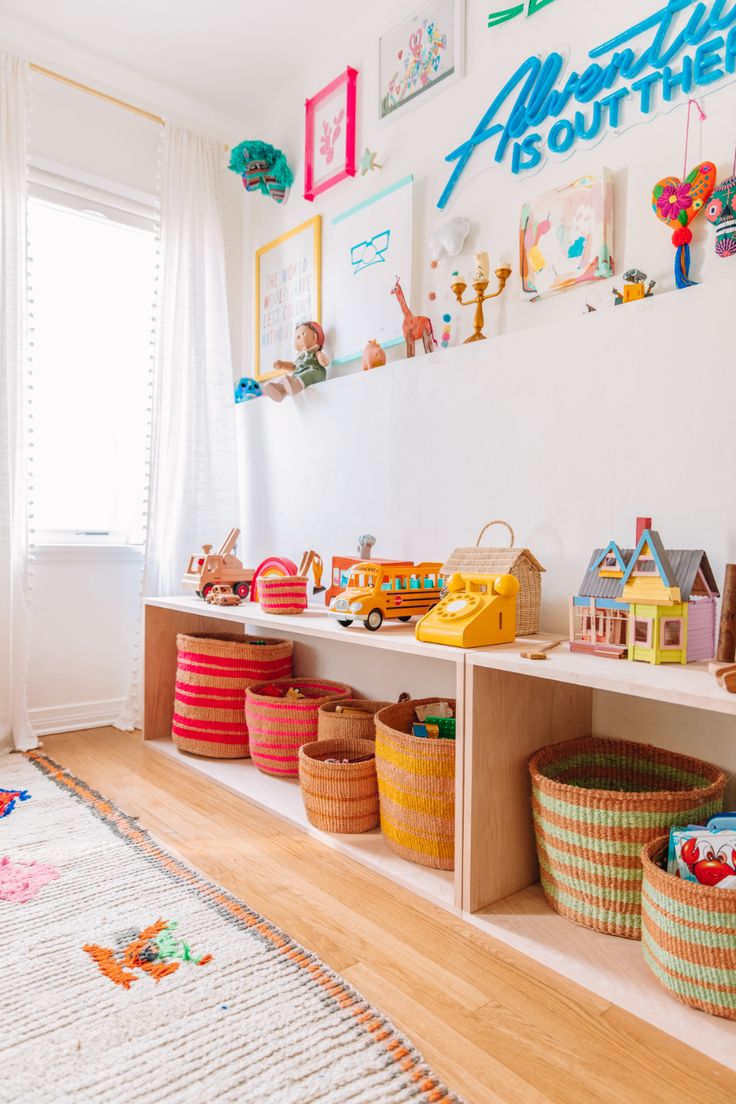 there are many baskets and toys on the shelves in this child's playroom