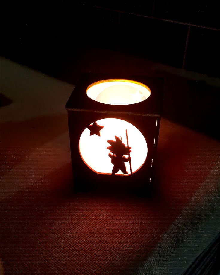 Black color lantern with purple hue with kid Goku and adult Goku silhouette. This anime is fro Dragon ball with Goku the main protagonist. Dragon Ball Decor, Dragon Ball Z, Michael Jackson, Tea Light Candle, Fun Crafts, Dragon Ball, Lanterns, Room Decor, Apartment