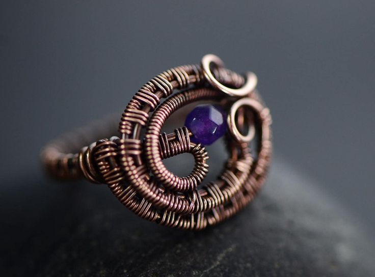 This one is unusual and will stand out from the crowd. Asymmetrical ring with deep purple colour enhanced amethyst gemstones set in pure aged copper.  It is designed and made by me from many meters of pure copper wire hand woven and layered to emphasize the texture and depth of the design and it's flow.  The ring is US size 7.5 or UK size P. It is about 1.5 cm tall and 1.8 cm wide in widest part of the front wire weave. A perfect jewellery for a confident lady who likes to show that she is uniqu Handmade Elegant Copper Rings, Handmade Purple Copper Jewelry, Unique Open Copper Ring Jewelry, Handmade Copper Open Ring, Unique Amethyst Open Ring, Adjustable Electroformed Purple Jewelry, Adjustable Purple Electroformed Jewelry, Unique Bronze Copper Rings, Handmade Spiral Rings With Unique Style