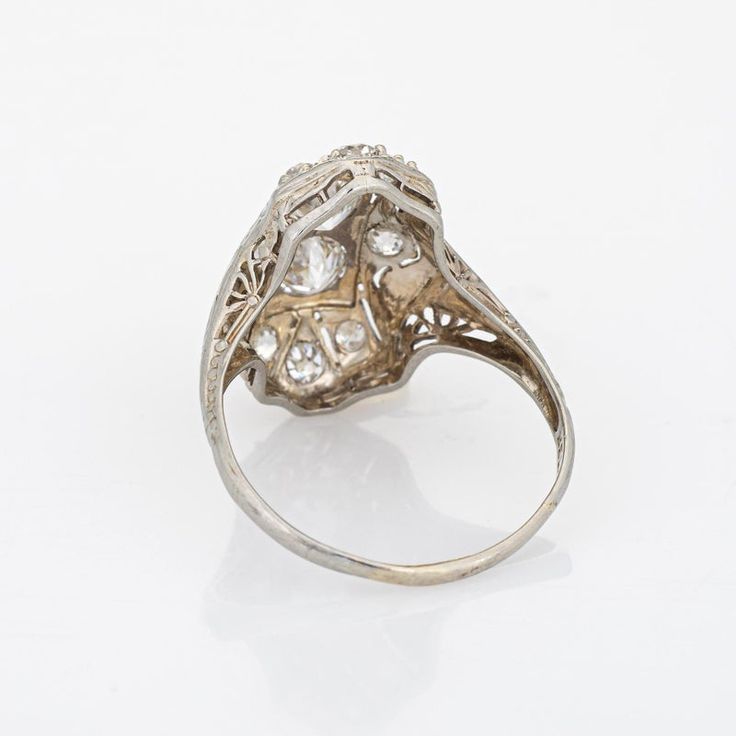 Elegant & finely detailed Belais Art Deco era ring (circa 1920s to 1930s) crafted in 14k white gold.   Two centrally mounted old European cut diamonds are estimated at 0.48 carats each. A further 8 old mine cut diamonds total an estimated 0.42 carats. The total diamond weight is estimated at 1.38 carats (I-J colour and VS2-I2 clarity).      Belais Brothers is a highly regarded and very collectible maker from the late 19th century to the early 20th century. The ring epitomises vintage charm and w Collectible Diamond White Platinum Diamond Ring, Collectible Platinum Diamond Ring In Diamond White, Antique Platinum Cluster Ring, Art Deco White Gold Cluster Ring In Platinum, Antique Collectible Platinum Ring, Vintage White Gold Diamond Cut Ring, Vintage Platinum Jewelry With Single Cut Diamonds, Luxury Vintage Platinum Jewelry With Single Cut Diamonds, Estate Style Diamond Rings With Accents