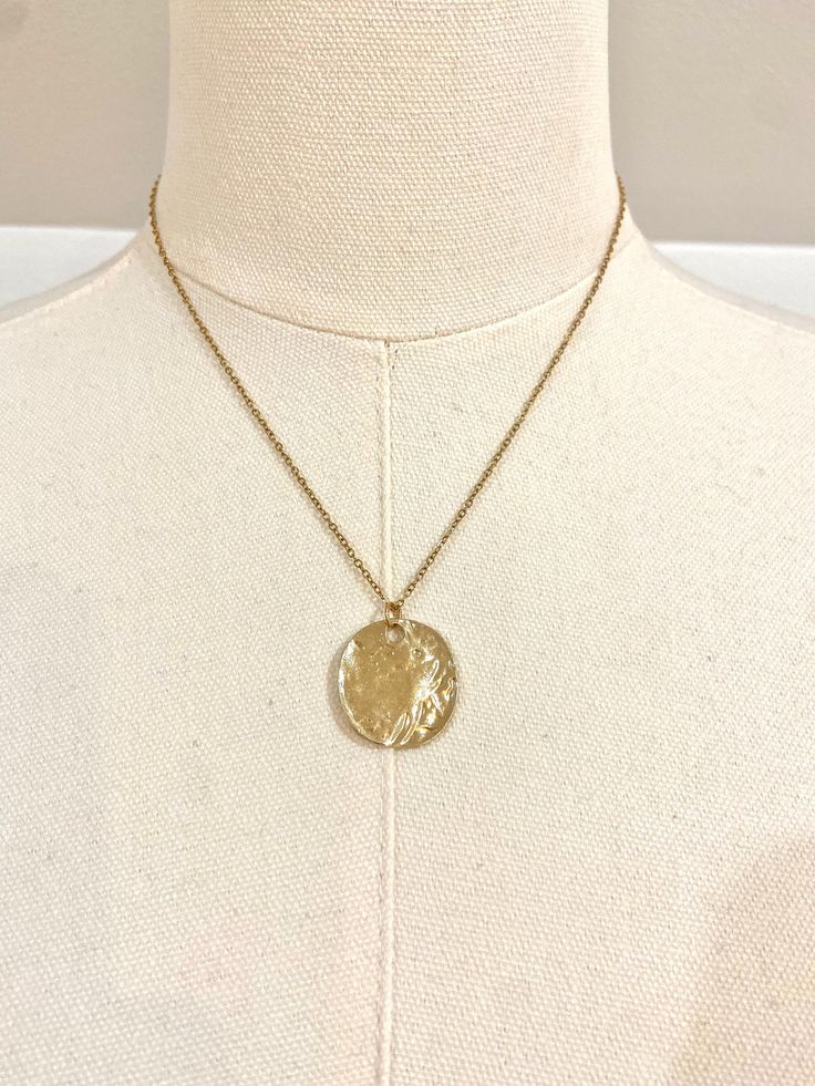 This beautiful 18k gold plated necklace can be worn as a statement piece or layered with other necklaces. Featuring a gold disc pendant, making for a perfect simplistic gold boho/beach style necklace.  ~Material~ High quality 18k gold plated stainless steel chain. ~Length~ 16 inches can be adjusted to 18 inches. M O R E * I N F O R M A T I O N ~Care instruction~ Please remove it before bathing or swimming. Avoid your jewelry touching chemicals such as hairsprays or perfumes. ~Shipping~ After rec Gold-tone Medallion Necklace With Coin Pendant, Brass Medallion Necklace Tarnish Resistant, Tarnish Resistant Brass Medallion Necklace, 14k Gold-filled Medallion Jewelry, 14k Gold Filled Medallion Jewelry, 14k Gold Filled Medallion Charm Necklace, Tarnish Resistant, Tarnish Resistant 14k Gold Filled Medallion Charm Necklace, Everyday Gold Plated Coin Jewelry, Yellow Gold Coin Charm Necklace With Adjustable Chain