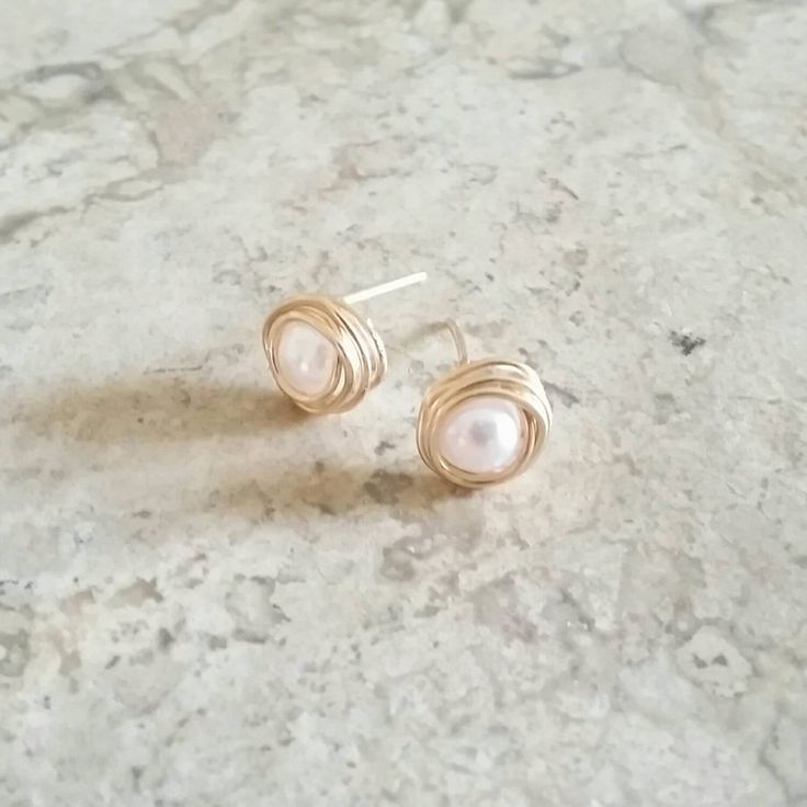 ♣ Free shipping on additional items These high quality white pearl stud earrings come in a gift box and are readily available as bridesmaids gifts, wedding jewelry, Mother's Day gifts and for any day wear! Each earrings are delicately handmade with freshwater Grade AAA 6mm pearls wrapped in 14k gold filled wire. They come with butterfly backs. M a t e r i a l s: 14k gold filled, rose gold filled or silver filled wire, Grade AAA freshwater white pearls ♥ Pearl Size: 6mm This listing is for a PAIR 14k Gold Filled White Bridal Earrings As Gift, White 14k Gold Filled Bridal Earrings As Gift, Yellow Gold Wire Wrapped Pearl Earrings Gift, 14k Gold Filled Wire Wrapped Earrings For Wedding, Wire Wrapped 14k Gold Filled Earrings For Wedding, 14k Gold Filled Wire Wrapped Wedding Earrings, 14k Gold Filled Dainty Bridal Earrings, Dainty 14k Gold Filled Bridal Earrings As Gift, Dainty 14k Gold Filled Bridal Earrings