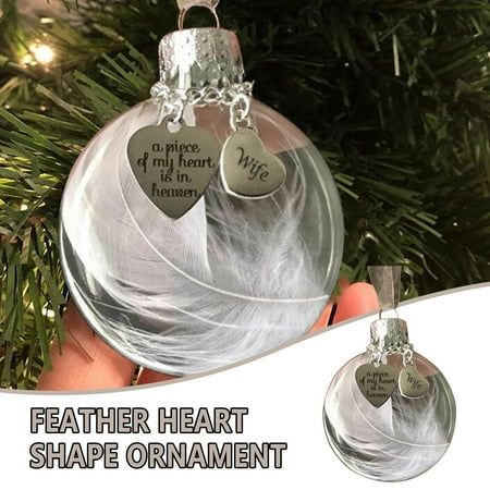 a glass ornament with two hearts hanging from it's side on a christmas tree