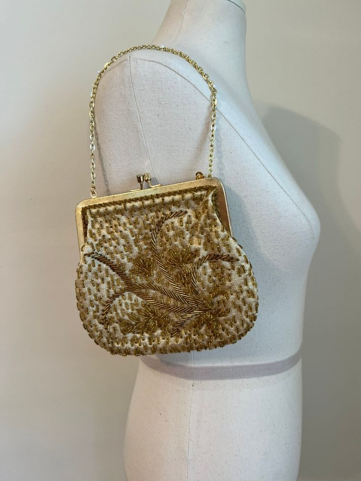 "Vintage coin purse Gold beaded details Measurements:  Width: 6.5\" Strap: 11.5\" Height: 6\" *ALL SALES FINAL.  ITEMS ARE VINTAGE, PRE-OWNED, & PRE-WORN.  I HAVE DONE MY BEST TO INSPECT AND MEASURE ITEMS, AND TO POINT OUT ANY FLAWS AND SIGNS OF WEAR.  IF YOU HAVE ANY QUESTIONS, PLEASE MESSAGE ME BEFORE YOU PURCHASE, AND I WILL BE HAPPY TO GIVE YOU ANY ADDITIONAL INFORMATION ABOUT THE ITEMS THAT I CAN.  BUT I WILL NOT ACCEPT RETURNS, NOR ISSUE REFUNDS." Antique Gold Embroidered Bags, Vintage Party Clutch With Handwork, Vintage Evening Bag With Handwork For Formal Occasions, Vintage Clutch With Handwork For Parties, Vintage Handwork Clutch For Party, Vintage Handwork Evening Bag For Party, Vintage Embellished Pouch Bag, Victorian Style Gold Embroidered Bag, Vintage Handwork Evening Bag For Wedding