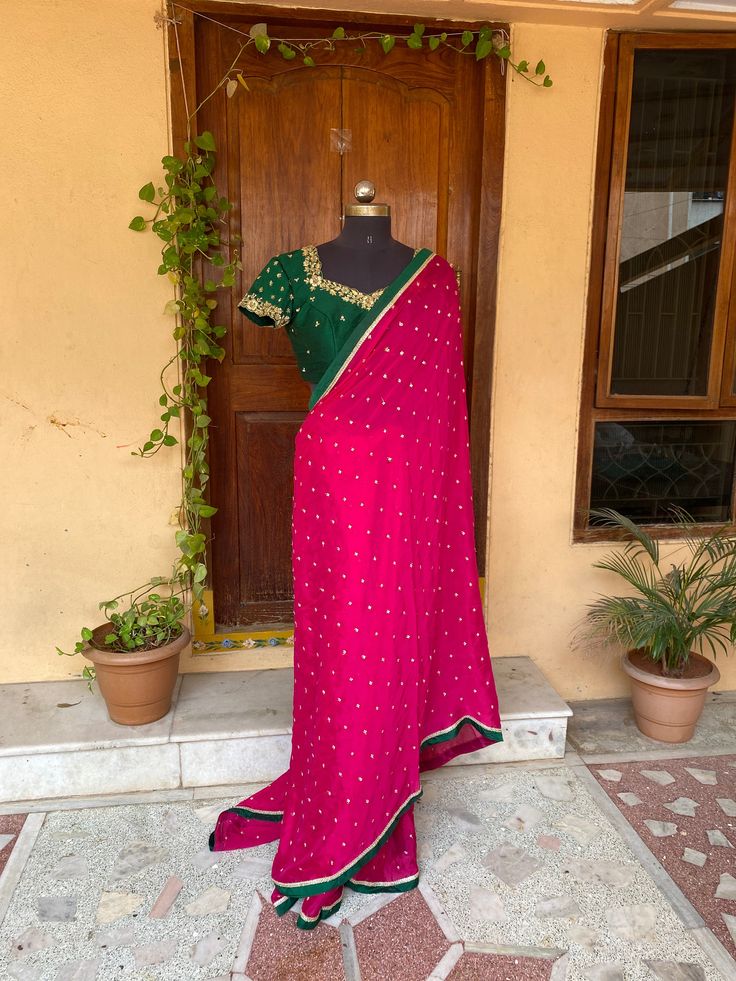 pink buti Chiffon silk saree with hand embroidery blouse  |traditional saree with readymade blouse | sarees USA | pure light weight silk saree / green saree with bottle green stitched blouse / voggish / short sleeve maggam blouse      you are absolutely gonna fall in love with this unique modern  saree look with our stitched ready to wear blouses(includes the price) with a modern touch to them is perfect for your upcoming saree occassion that really makes you stand apart in crowd !!     You dont really need to stress your self in finding matching blouses for our sarees !! we pretty much carry our sarees with trendy stitched blouses or we will help you with our mix and match collection !!      Its a beautiful simple chiffon  saree in pink color with butis all over finished with lace details Pink Raw Silk Saree With Dori Work, Pink Dola Silk Pre-draped Saree With Dori Work, Pink Pre-draped Saree With Unstitched Blouse In Chinon, Pink Pre-draped Chinon Saree With Unstitched Blouse, Pink Traditional Wear With Unstitched Blouse In Chinon, Pink Chinon Traditional Wear With Unstitched Blouse, Pink Traditional Wear With Unstitched Chinon Blouse, Pink Chanderi Blouse For Traditional Ceremonies, Pink Banarasi Silk Blouse Piece With Dori Work