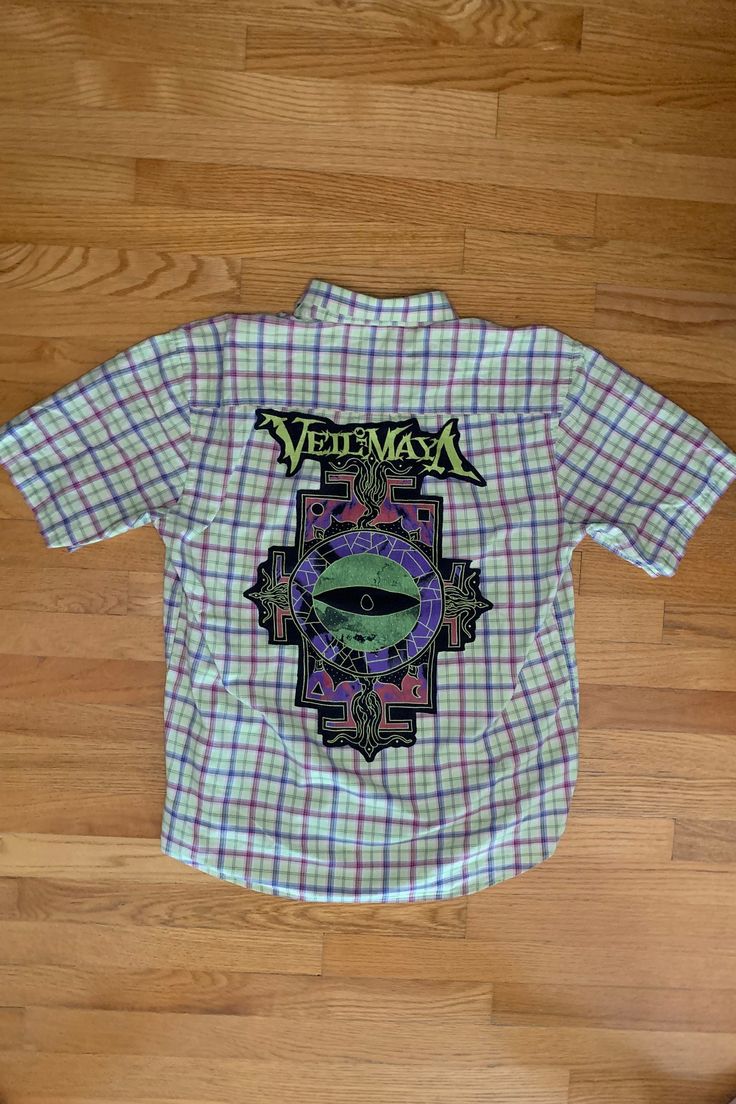 One-of-a-kind Short Sleeve Button-up featuring the band, Veil of Maya  Thrifted and Prewashed 100% cotton button-up with thrifted t-shirt print stitched to the back.   Size Large  Measurements: ♥  Shoulders: 20.5" ♥  Chest: 24.5" ♥  Sleeve: 10.75" ♥  Length: 26" . . . . . . . . . . . . . . . . . . . . . . . . . . . . . . . . . . . . . . . . . . . . . Handmade ♥ Thrifted ♥ Recycled ♥ Upcycled These shirts are created with button-ups and shirts that need a second life and once they are combined they become unique one of a kind items!  The shirts are MEN'S sizes but can be worm by both men and women!  For a more baggy, comfy, and oversized fit, order a size up from your regular size. . . . . . . . . . . . . . . . . . . . . . . . . . . . . . . . . . . . . . . . . . . . . . If you have any ques Y2k Cotton Tops With Button Closure, Cotton Graphic Print Button-up Shirt, Casual Streetwear Shirt With Vintage Print, Casual Shirt With Vintage Print For Streetwear, Cotton Grunge Shirt For Spring, Y2k Short Sleeve Cotton Shirt, Printed Cotton Shirt For Festival, Spring Cotton Grunge Shirt, Festival Cotton Tops With Buttons