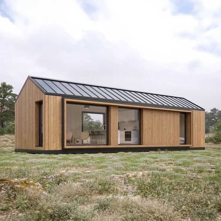 a small wooden cabin in the middle of a field