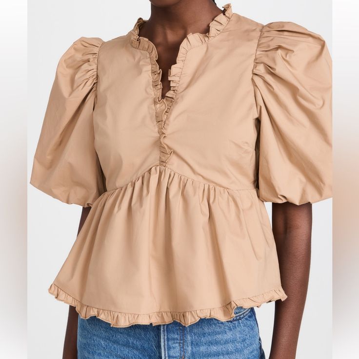 Beautiful Tan Color With Ruffle Detail And Peplum Bottom And Puff Sleeves Fits Better For Small Chests Beige Puff Sleeve Top With Ruffles, Feminine Puff Sleeve Top With Ruffles For Day Out, Feminine Puff Sleeve Top With Ruffle Hem For Brunch, Chic Puff Sleeve Top With Ruffles For Day Out, Feminine Ruffle Puff Sleeve Tops, Feminine Ruffled Puff Sleeve Tops, Day Out Blouse With Puff Sleeves And Ruffles, Puff Sleeve Ruffle Blouse For Day Out, Feminine Spring Puff Sleeve Top With Ruffles