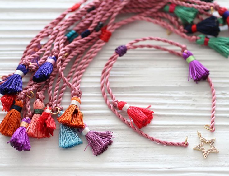 Great bracelet finding! Just attach a charm, gemstone or any of your designs to the loops at the edges of the cord bracelet and easily adjust it to the length you want! And, it is ready to wear! Perfect for layering! Please note that charms are sold separately! Adjustable blush pink cord bracelet with tassels, DIY cord bracelet, semi-ready cord bracelet, adjustable pink string bracelet, blush Important note: You will receive random tassel colors with this cord bracelet. 230 mm (9 inches) while i Pink Bohemian Braided Bracelet With Sliding Knot, Bohemian Pink Braided Bracelet With Sliding Knot, Pink Adjustable Cord Bracelet For Friendship, Pink Macrame Braided Bracelet For Friendship, Pink Macrame Friendship Bracelets, Pink Braided Friendship Bracelet With Adjustable Cord, Pink Braided Bracelet With Adjustable Cord For Friendship, Pink Adjustable Braided Friendship Bracelet, Pink Adjustable Braided Bracelet For Friendship