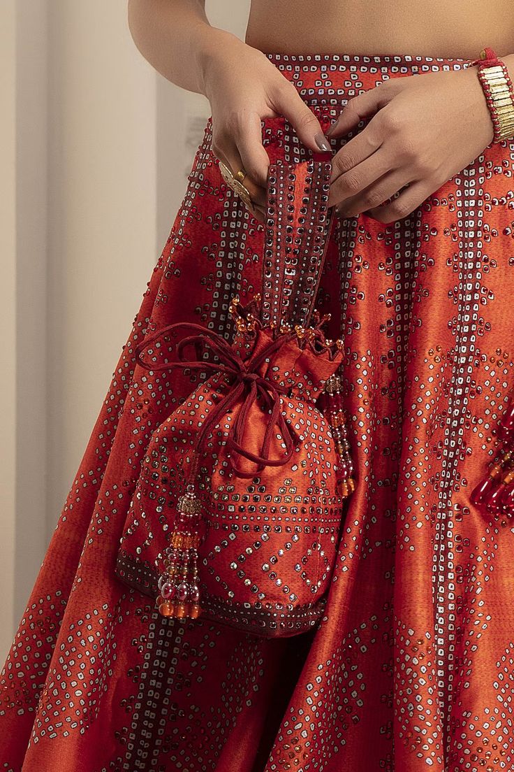 Buy The Garnish Company Printed Polti Bag Online | Aza Fashions Polti Bag, Orange And Fuschia, Bead Tassels, Cape Jumpsuit, Potli Bag, Geometric Motif, Jumpsuit Skirt, Orange Bag, Designer Gowns