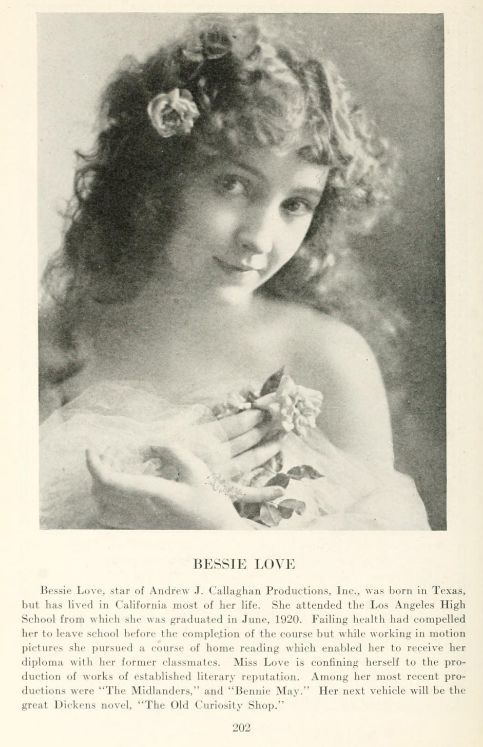 an old black and white photo of a woman in a wedding dress holding a flower